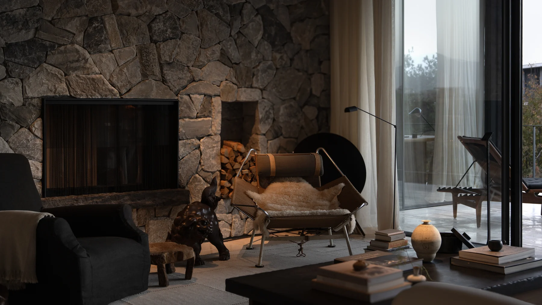 Wu Bin Residence stone fireplace and lounge chair